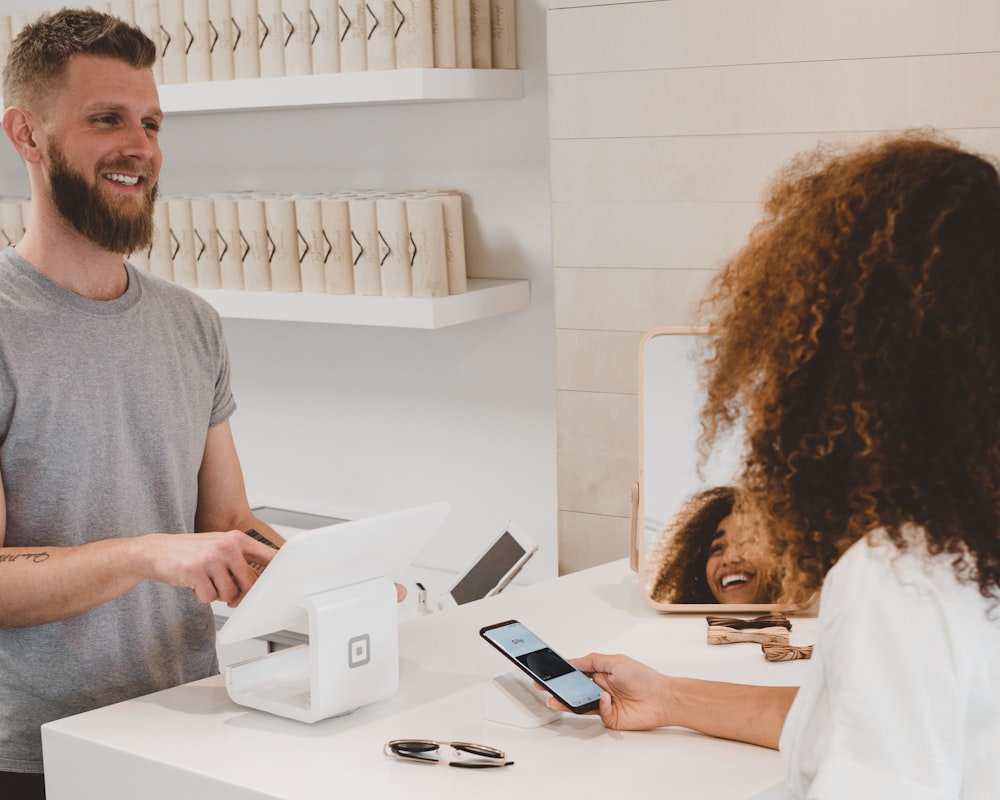 Customer tapping a card at a local store counter